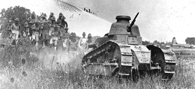 A Renault FT-17 tank rolls through the prairie, followed by infantry on foot. A Renault FT-17 tank rolls through the prairie, followed by infantry on foot.